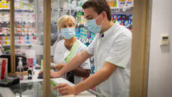 Pharmacists working at a community pharmacy during the COVID-19 pandemic