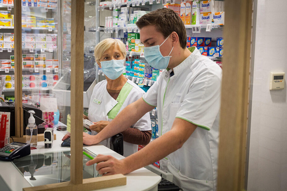 Pharmacists working at a community pharmacy during the COVID-19 pandemic