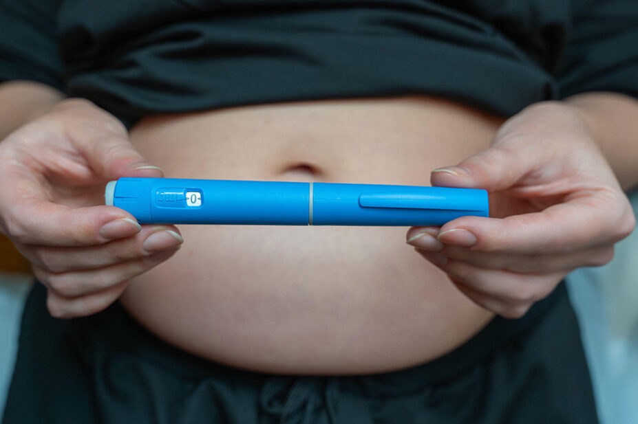A woman holds a weight-loss pen