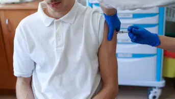 A teenager receives a vaccination
