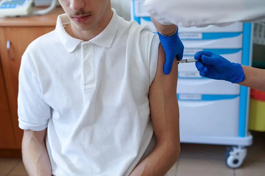 A teenager receives a vaccination