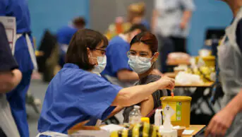 A student receiving an injection in the sports hall at the University of Kent campus in Canterbury as the number of cases of meningitis being investigated by the UK Health Security Agency (UKHSA) in Kent