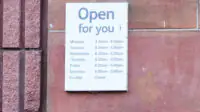 Business shop opening hours day and time sign, showing Sunday as closed