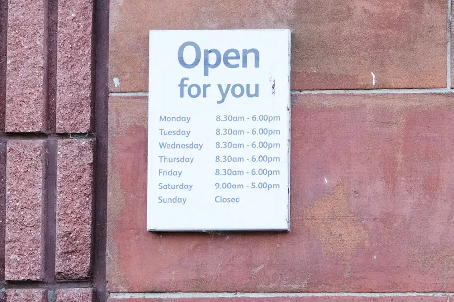 Business shop opening hours day and time sign, showing Sunday as closed