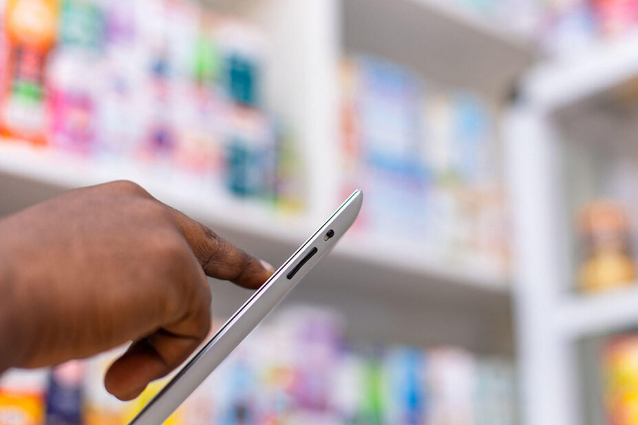 Pharmacist using tablet in a pharmacy setting