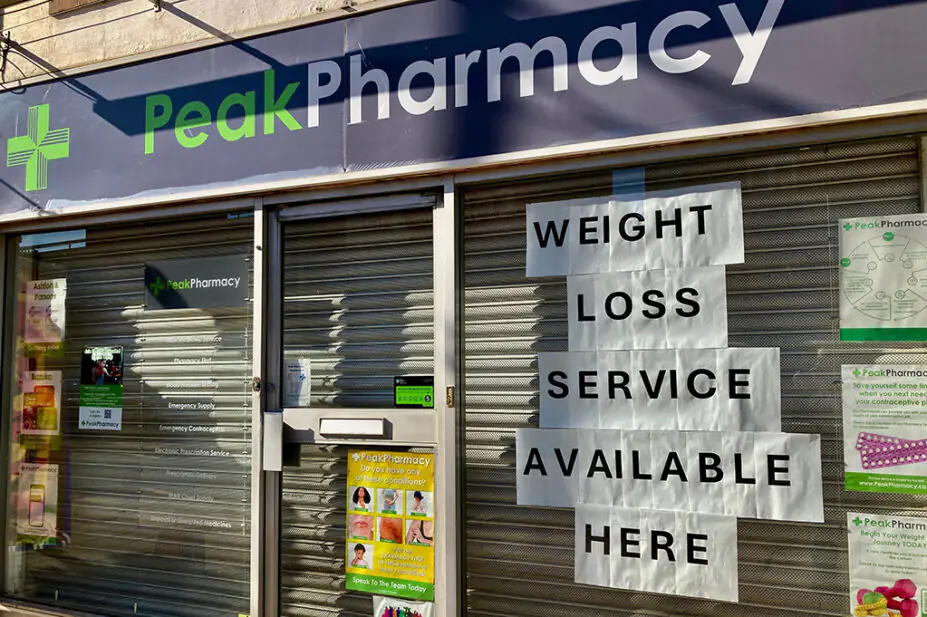 Notice of weight-loss service in window of local community pharmacy
