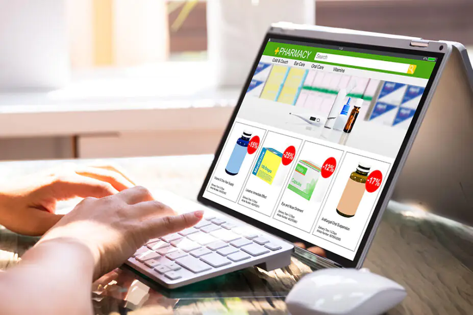 A person uses an online pharmacy on their laptop