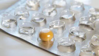 A blister pack of medicine with only one tablet remaining