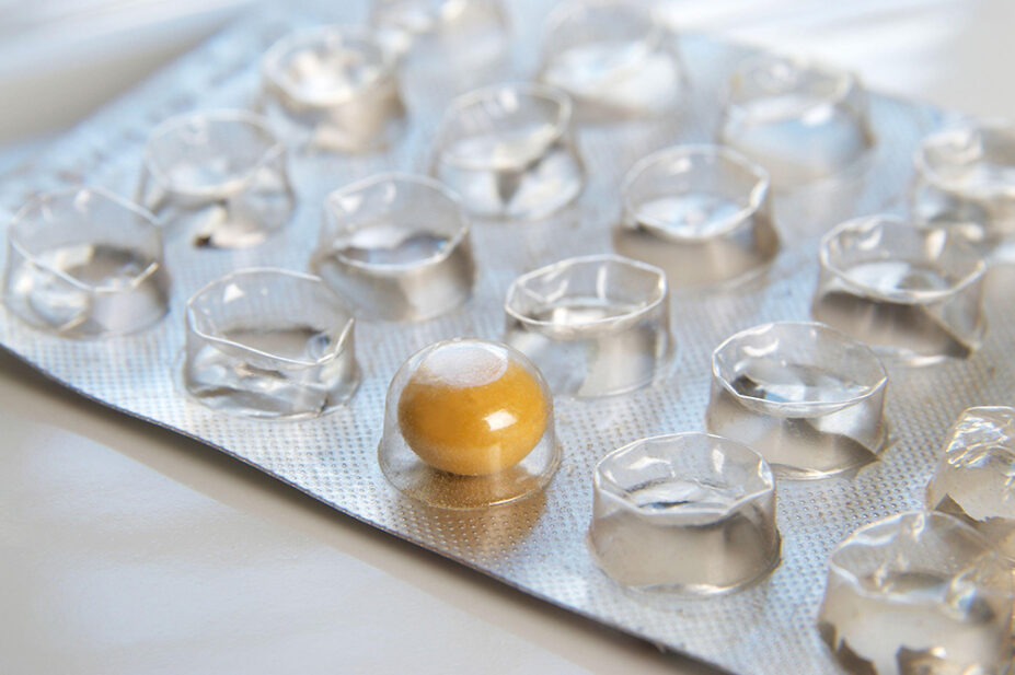 A blister pack of medicine with only one tablet remaining