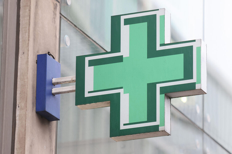 The green sign outside of a community pharmacy