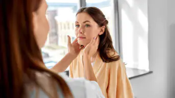 A healthcare professional checks a patient's lymph nodes