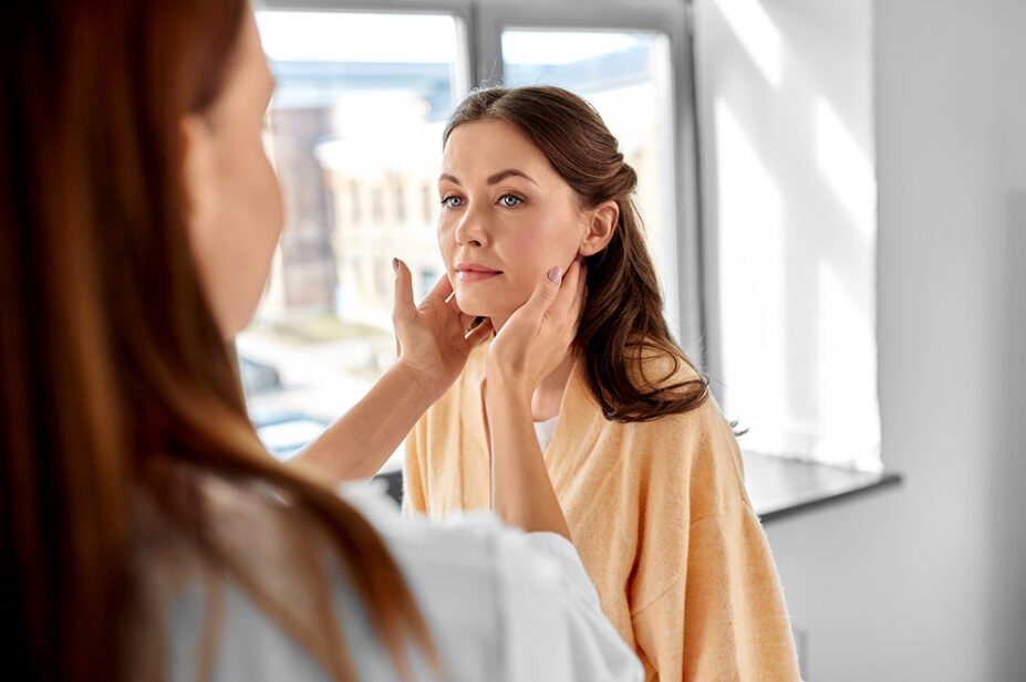 A healthcare professional checks a patient's lymph nodes