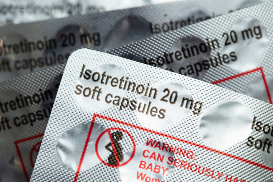 Packs of isotretinoin 20mg soft capsules with warning label in red and an image of pregnant women with a red line across it