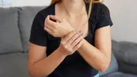 A woman experiences wrist pain