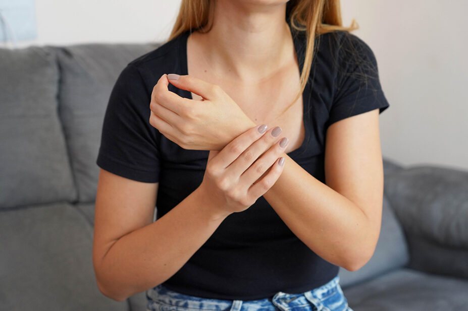 A woman experiences wrist pain
