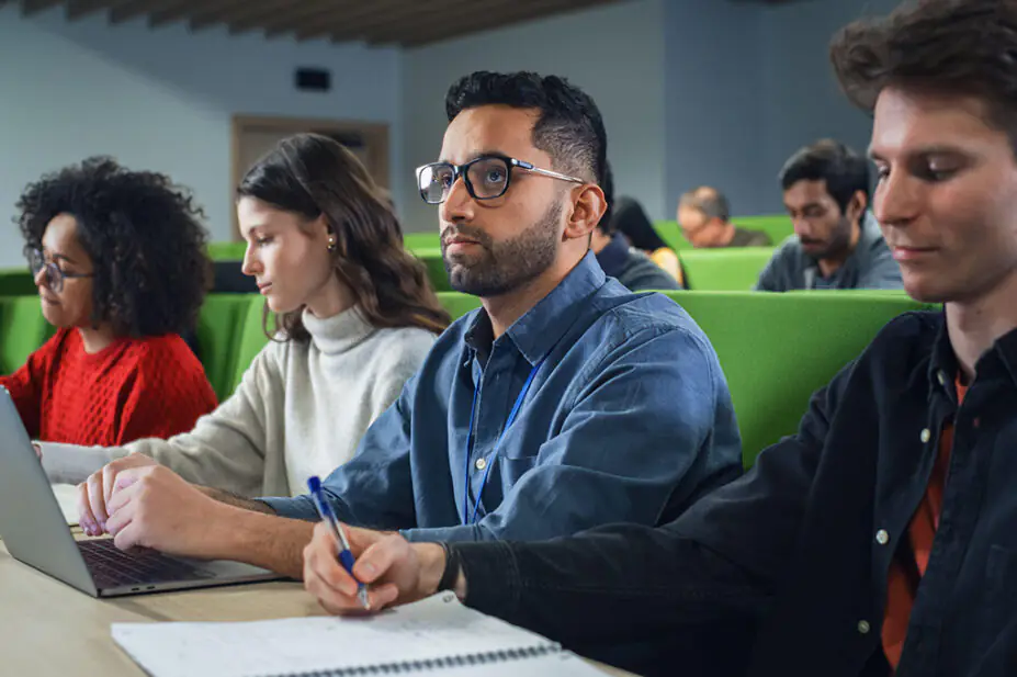 University students take notes in class