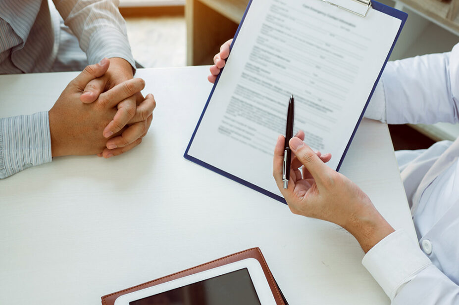 A doctor conducts a structured medication review with a patient