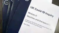 An image of several copies of the UK COVID-19 inquiry report