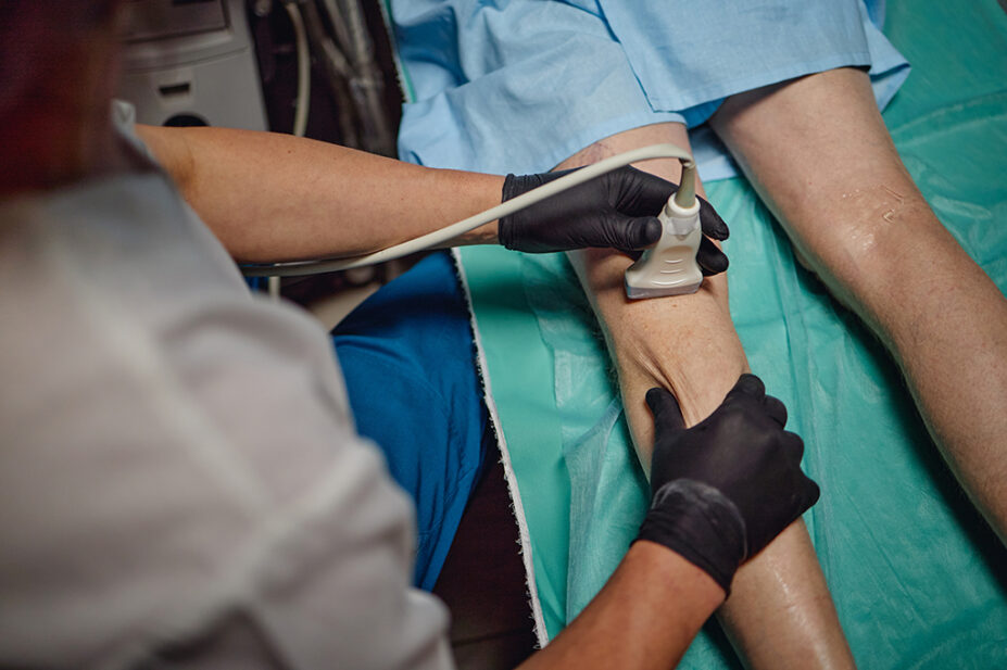 Older man having ultrasound scan on leg