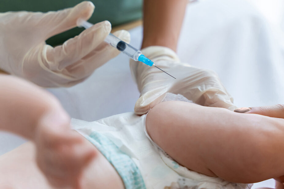 A baby receives a vaccination from a healthcare professional