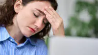 A woman suffers from a migraine