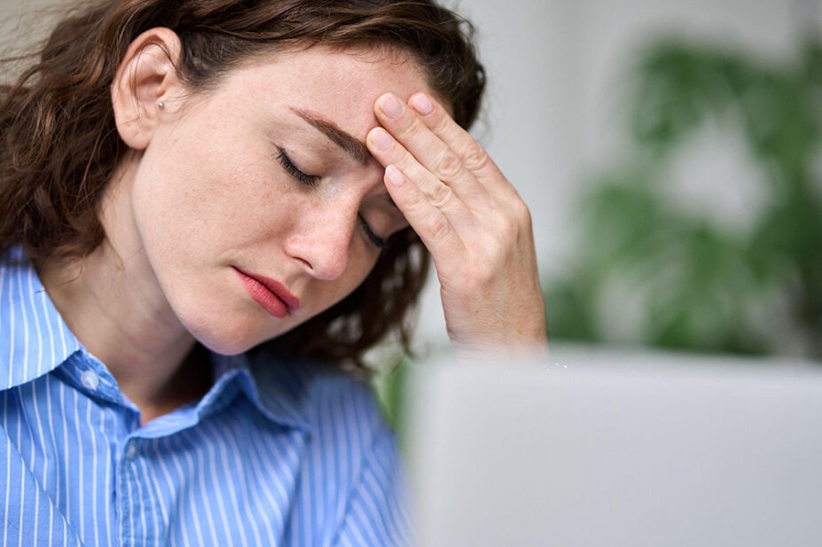 A woman suffers from a migraine