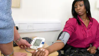 A woman receives a blood pressure check