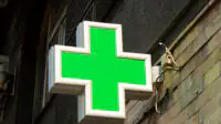 The pharmacy sign outside of a community pharmacy