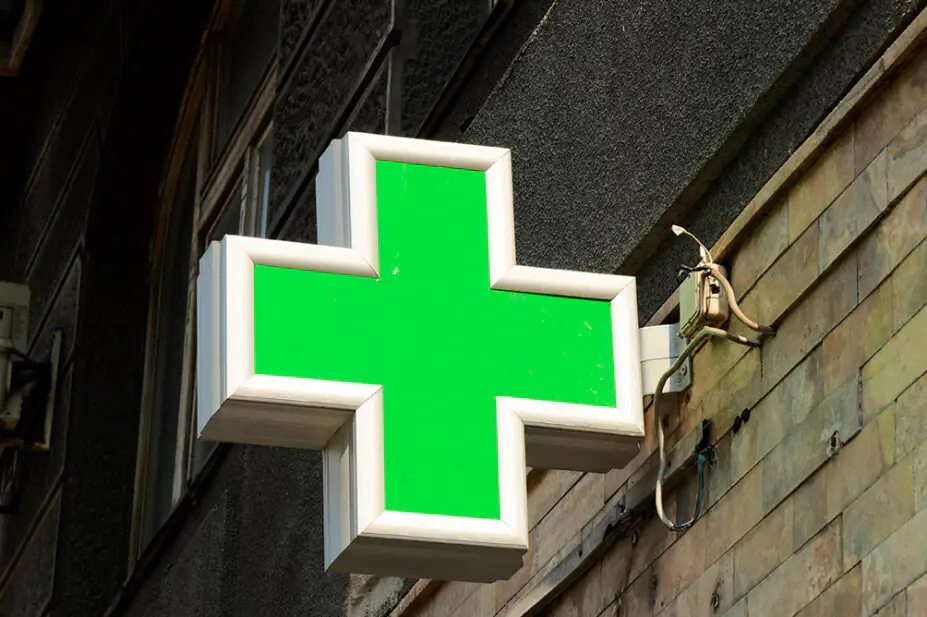 The pharmacy sign outside of a community pharmacy