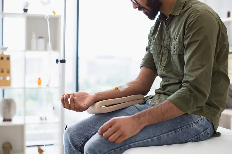 A man receives cancer treatment via an IV