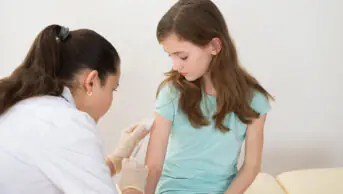 A child receives a vaccination from a healthcare professional