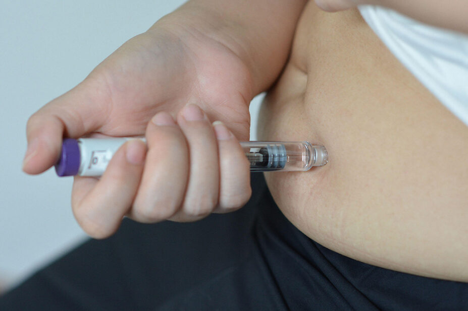 A person uses a weight-loss injection pen