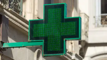 Close-up of pharmacy sign on the exterior of a building in London