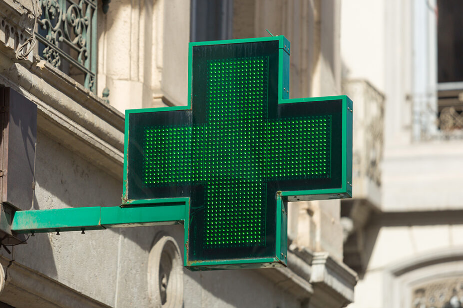 Close-up of pharmacy sign on the exterior of a building in London