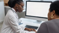 Female doctor with a female patient, suggestive of women's health