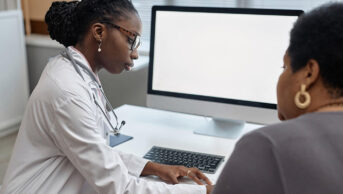 Female doctor with a female patient, suggestive of women's health