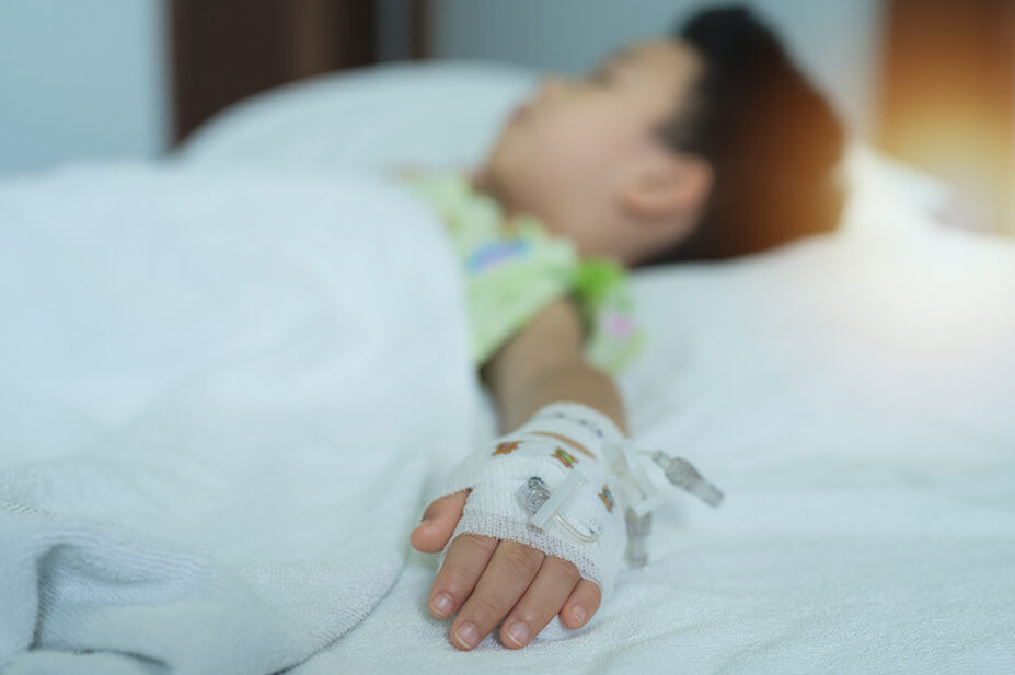 Young child with cannula in hospital bed