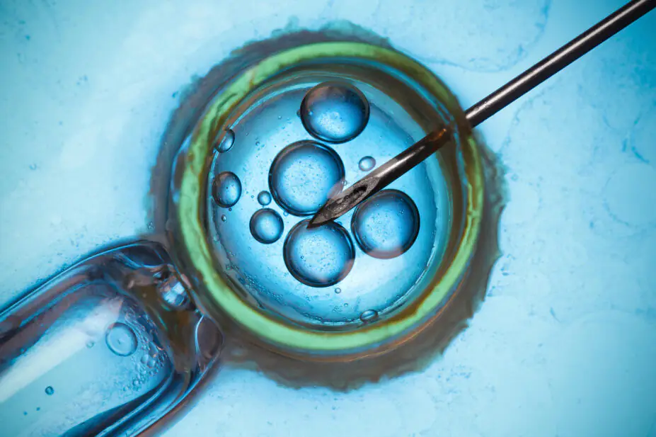 Blue background, IVF injection into egg concept. Text reading 