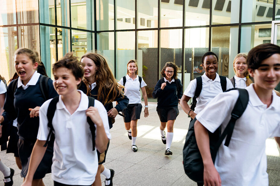 A group of teenagers in school uniform walking together