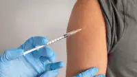 A young person receives a vaccination