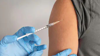A young person receives a vaccination