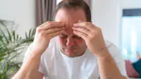 A man suffers from a migraine