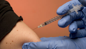 A patient receives a vaccination