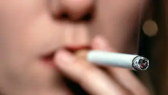 A woman smokes a cigarette