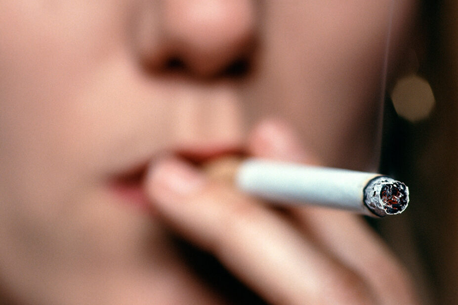A woman smokes a cigarette