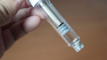 A person holds a weight-loss injection pen
