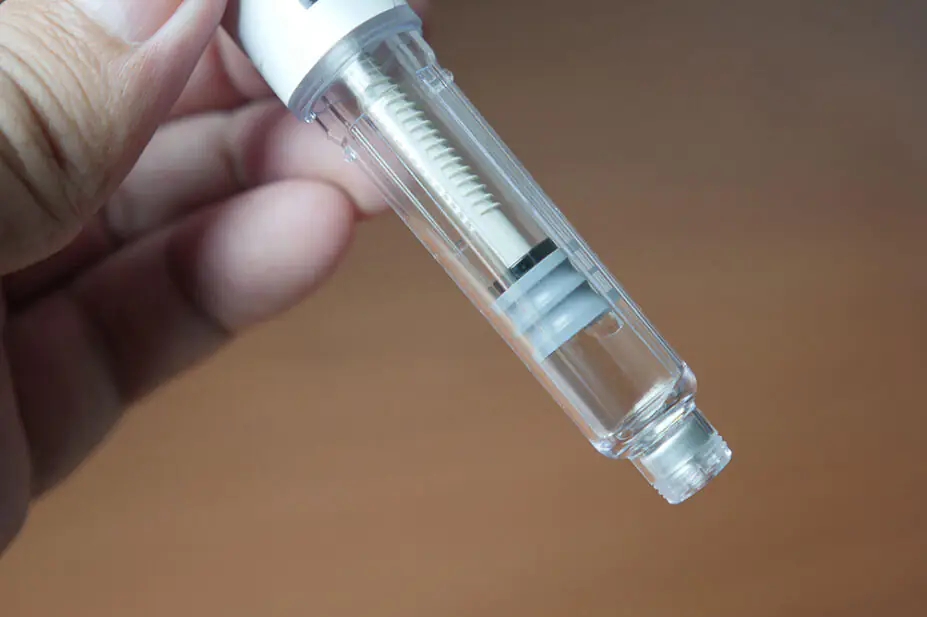 A person holds a weight-loss injection pen