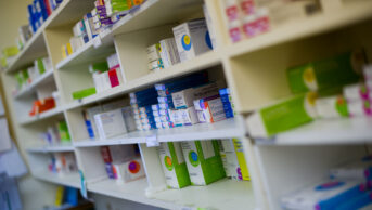 Dispensary chemist display shelves of drugs and packets