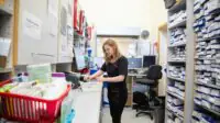 Pharmacist organizing medication in a pharmacy