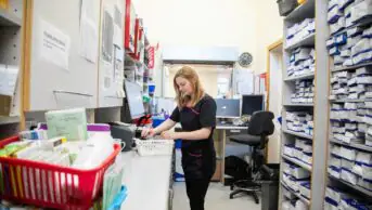 Pharmacist organizing medication in a pharmacy